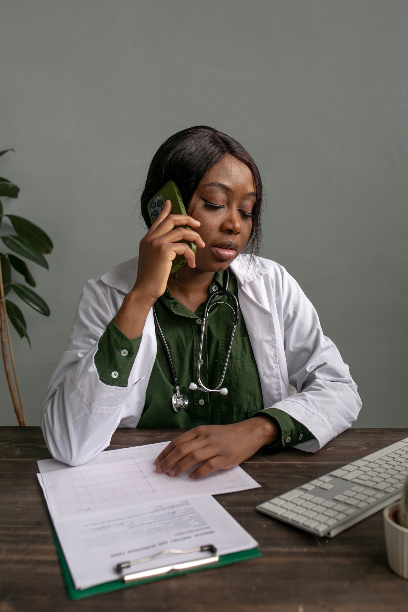 Green Medicine Female Doctor on a Phone Call